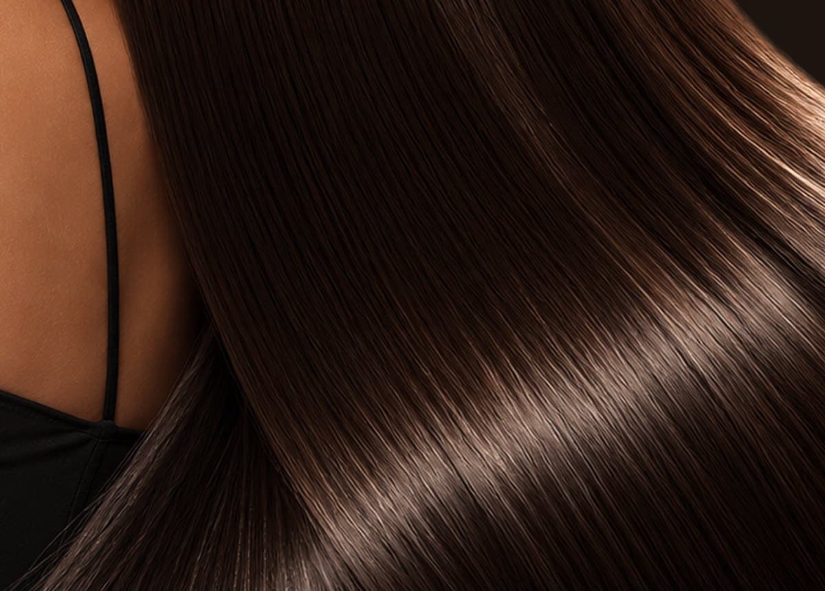 Close-up of glossy, smooth hair over the shoulder